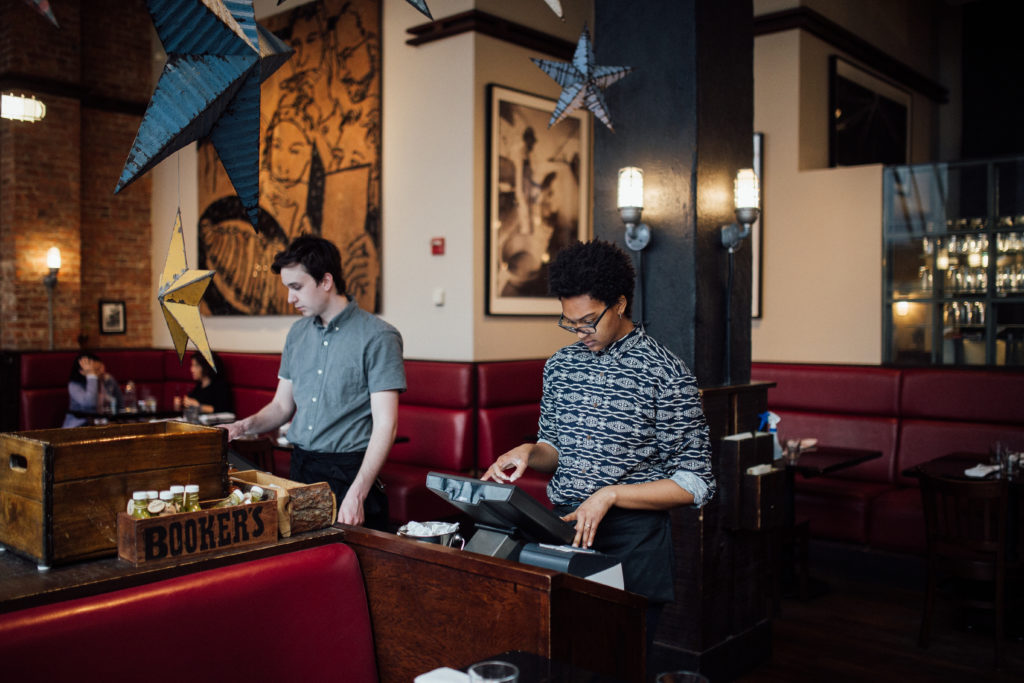 Photo of two servers at standing at a counter at Blue Smoke (an Avero customer) for the Create a Restaurant Schedule That Boosts Profit blog article. 