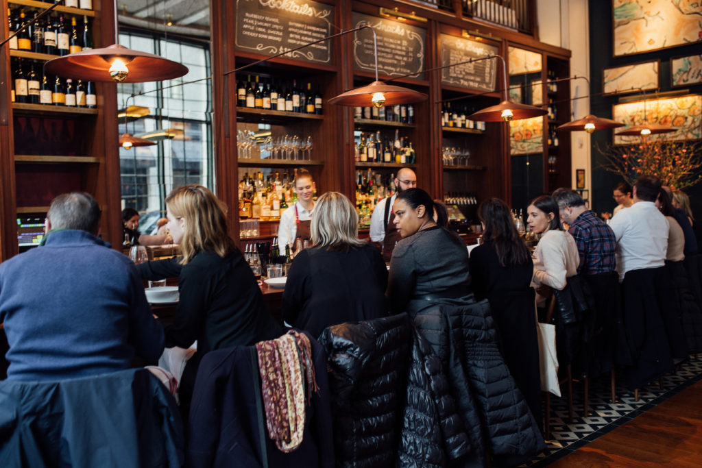 Photograph of several people seated at the bar in NYC's Gramercy Tavern.
