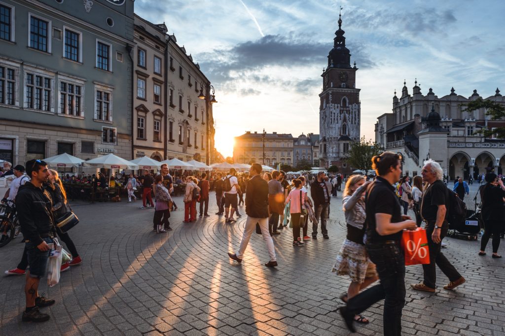 Photo of people in Main Market Square in Krakow, Poland. Photo by Jacek Dylag on Unsplash. 