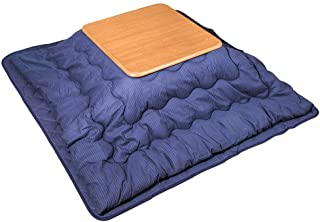 Photograph of a Japanese kotatsu table featuring a puffy blue blanket over a hidden heat source with a square table top placed on top.  